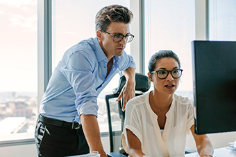 Two people looking at a computer screen